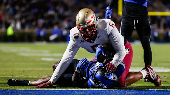 Oct 18, 2024; Durham, North Carolina, USA; Duke Blue Devils quarterback Maalik Murphy (6) is tacked by Florida State Seminoles defensive lineman Darrell Jackson Jr. (6). Oct 18, 2024; Durham, North Carolina, USA; Duke Blue Devils quarterback Maalik Murphy (6) is tacked by Florida State Seminoles defensive lineman Darrell Jackson Jr. (6).