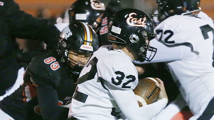 Ames' offensive line Colden Bray (85) takes down Sioux City East's running back Myles Wegher (32) during the fourth quarter at Ames High Football field on Friday, Oct. 13, 2023, in Ames, Iowa.
