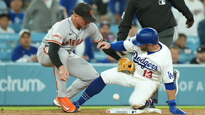 May 14, 2026; Los Angeles, California, USA;  Los Angeles Dodgers third baseman Max Muncy (13) is safe at third against San Francisco Giants third baseman Matt Chapman (26) in the sixth inning at Dodger Stadium. Mandatory Credit: Kirby Lee-Imagn Images