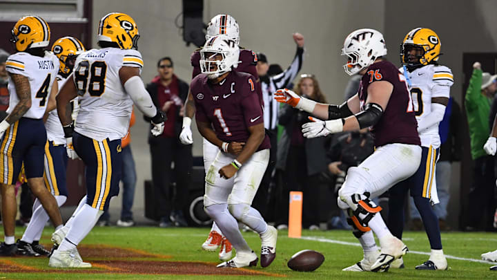 Oct 24, 2025; Blacksburg, Virginia, USA; Virginia Tech Hokies quarterback Kyron Drones (1) and offensive lineman Aidan Lynch (76) celebrate a touchdown during the first overtime period against the California Golden Bears at Lane Stadium. Mandatory Credit: Brian Bishop-Imagn Images
