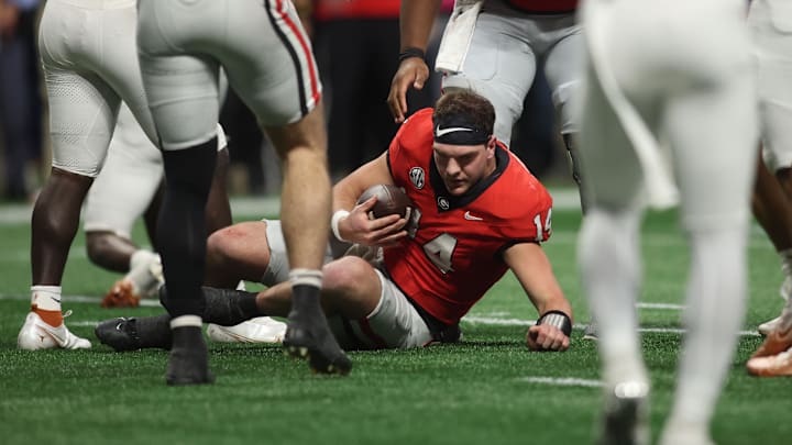 Dec 7, 2024; Atlanta, GA, USA; Georgia Bulldogs quarterback Gunner Stockton (14) rushes the ball for a first down in overtime against the Georgia Bulldogs in the 2024 SEC Championship game at Mercedes-Benz Stadium. Mandatory Credit: Brett Davis-Imagn Images