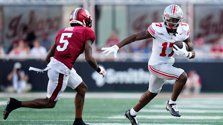 Ohio State Buckeyes wide receiver Carnell Tate (17) runs from Indiana Hoosiers defensive back Kobee Minor (5) Ohio State Buckeyes wide receiver Carnell Tate (17) runs from Indiana Hoosiers defensive back Kobee Minor (5)
