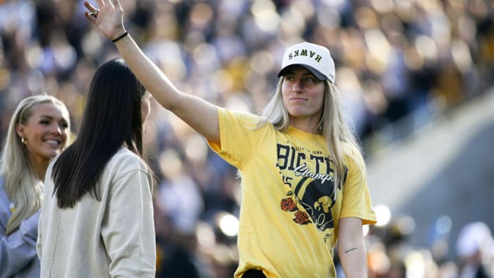 Iowa women’s basketball alumn Kate Martin waves to the crowd during an Iowa football game against Northwestern.