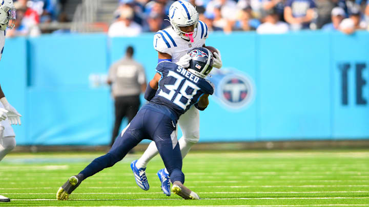 Oct 13, 2024; Nashville, Tennessee, USA;   Indianapolis Colts wide receiver Josh Downs (1) runs the ball as Tennessee Titans cornerback L'Jarius Sneed (38) defends during the second half at Nissan Stadium. Mandatory Credit: Steve Roberts-Imagn Images