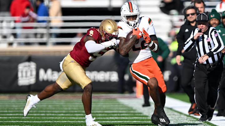 Nov 24, 2023; Chestnut Hill, Massachusetts, USA; Miami Hurricanes running back Mark Fletcher Jr. (22) runs against Boston College Eagles linebacker Kam Arnold (5) during the first half at Alumni Stadium. Mandatory Credit: Brian Fluharty-Imagn Images