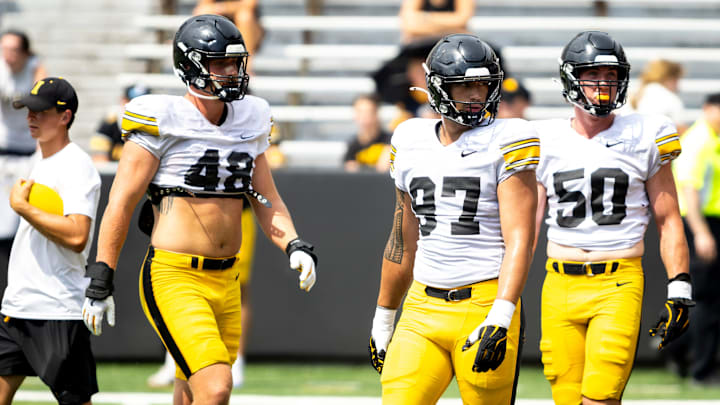 Aug 9, 2025; Iowa defensive linemen Max Llewellyn (48) Iose Epenesa (97) and Will Lockhart (50) listen to instructions during the Hawkeyes Kids Day NCAA football open practice at Kinnick Stadium in Iowa City, Iowa. Mandatory Credit: Joseph Cress for the Des Moines Register