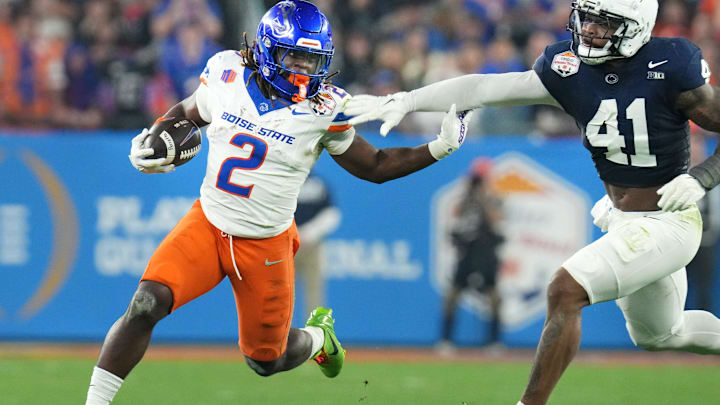 Boise State Broncos running back Ashton Jeanty runs past Penn State Nittany Lions linebacker Kobe King.