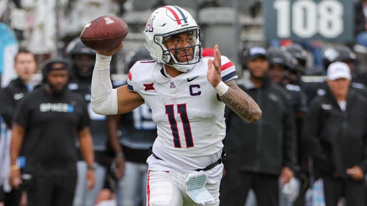 Nov 2, 2024; Orlando, Florida, USA; Arizona Wildcats quarterback Noah Fifita (11) rolls out to pass against the UCF Knights during the second quarter at FBC Mortgage Stadium. Nov 2, 2024; Orlando, Florida, USA; Arizona Wildcats quarterback Noah Fifita (11) rolls out to pass against the UCF Knights during the second quarter at FBC Mortgage Stadium.