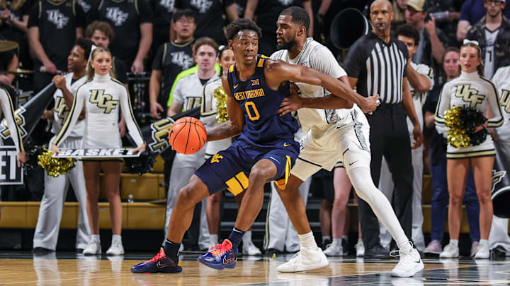 Feb 14, 2026; Orlando, Florida, USA; UCF Knights forward Devan Cambridge (35) defends West Virginia Mountaineers forward Brenen Lorient (0) during the second half at Addition Financial Arena. Mandatory Credit: Mike Watters-Imagn Images Feb 14, 2026; Orlando, Florida, USA; UCF Knights forward Devan Cambridge (35) defends West Virginia Mountaineers forward Brenen Lorient (0) during the second half at Addition Financial Arena. Mandatory Credit: Mike Watters-Imagn Images