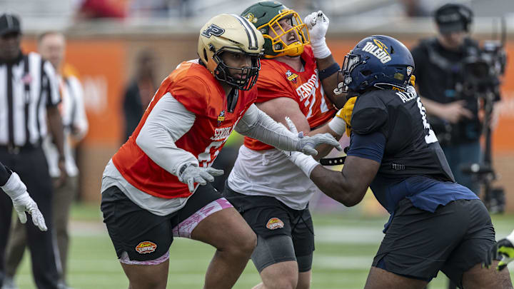 National team offensive lineman Grey Zabel of North Dakota State (77) and National team defensive lineman Darius Alexander of Toledo (9) battle through drills during Senior Bowl practice for the National team at Hancock Whitney Stadium. Also pictured is National team offensive lineman Marcus Mbow of Purdue (63). 
