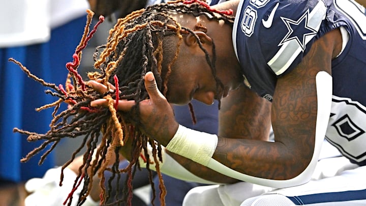 Dallas Cowboys wide receiver CeeDee Lamb sits on the bench before the start of the game against the Los Angeles Rams.