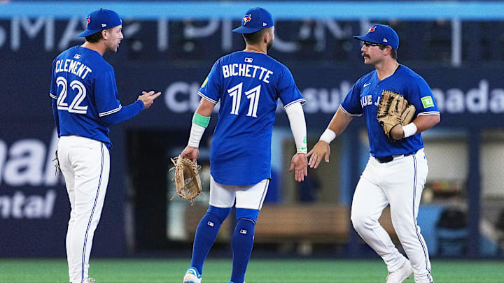 Aug 27, 2025; Toronto, Ontario, CAN; Toronto Blue Jays shortstop Bo Bichette (11) celebrates the win with Toronto Blue Jays left ielder Davis Schneider (36) against the Minnesota Twins at the end of the ninth inning at Rogers Centre