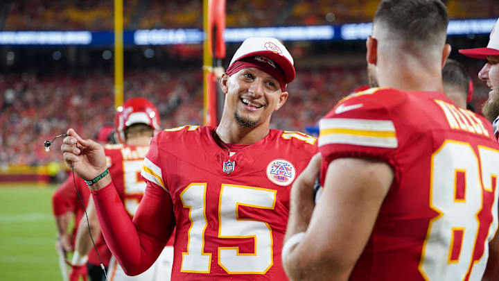 Aug 22, 2025; Kansas City, Missouri, USA; Kansas City Chiefs quarterback Patrick Mahomes (15) talks with tight end Travis Kelce (87) on  the sidelines against the Chicago Bears during the first half of the game at GEHA Field at Arrowhead Stadium. Mandatory Credit: Denny Medley-Imagn Images