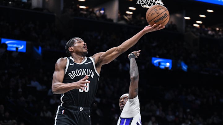 Mar 29, 2026; Brooklyn, New York, USA; Brooklyn Nets guard Ochai Agbaji (30) shoots the ball while defended by Sacramento Kings guard/forward Daeqwon Plowden (29) during the first half at Barclays Center. Mandatory Credit: John Jones-Imagn Images