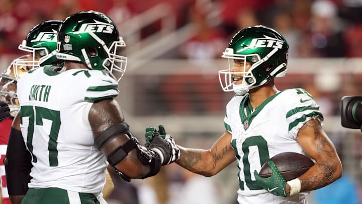 Sep 9, 2024; Santa Clara, California, USA; New York Jets wide receiver Allen Lazard (10) is congratulated by offensive tackle Tyron Smith (77) after catching a touchdown pass against the San Francisco 49ers during the fourth quarter at Levi's Stadium. 