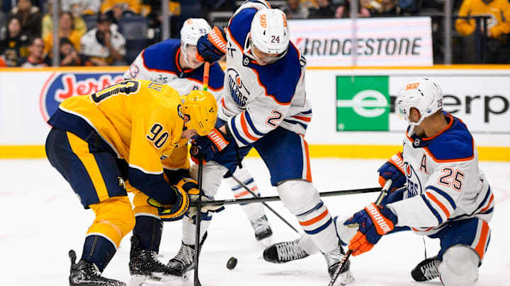 Edmonton Oilers defenseman Darnell Nurse (25) and defenseman Evan Bouchard (2) block the shot of Nashville Predators center Ryan O'Reilly (90) 