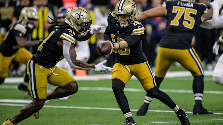 Oct 17, 2024; New Orleans, Louisiana, USA;  New Orleans Saints quarterback Spencer Rattler (18) hands off to New Orleans Saints running back Alvin Kamara (41) during the first quarter against the Denver Broncos at Caesars Superdome. 