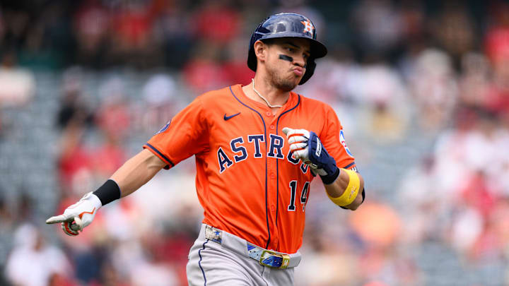 Houston Astros shortstop Mauricio Dubon (14) gestures after hitting a single in an orange jersey