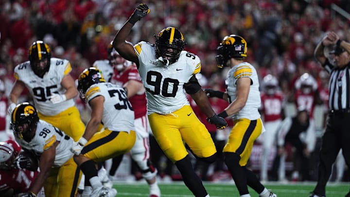 Oct 11, 2025; Madison, Wisconsin, USA; Iowa Hawkeyes defensive end Brian Allen Jr. (90) celebrates after causing a tipped ball that led to a interception by Bryce Hawthorne (96) against the Wisconsin Badgers at Camp Randall Stadium. Mandatory Credit: Ross Harried-Imagn Images