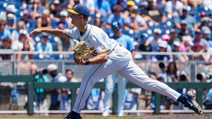 Jun 17, 2026; Omaha, NE, USA; West Virginia Mountaineers starting pitcher Chansen Cole (35) throws the opening pitch against the North Carolina Tar Heels at Charles Schwab Field. Mandatory Credit: Dylan Widger-Imagn Images