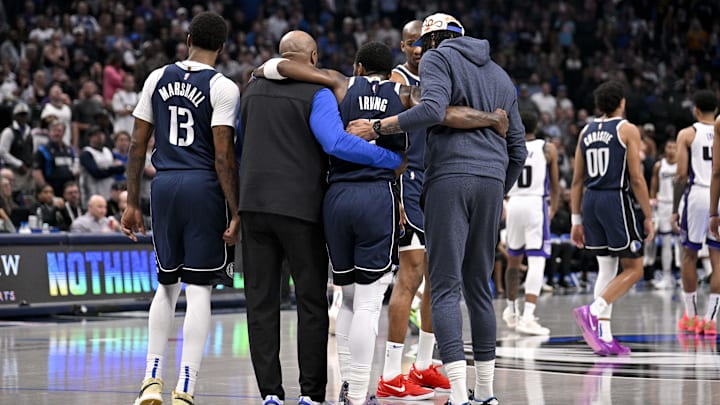 Mar 3, 2025; Dallas, Texas, USA; Dallas Mavericks guard Kyrie Irving (11) is helped off the court by forward Naji Marshall (13) and forward Anthony Davis (3) during the second quarter against the Sacramento Kings at the American Airlines Center. Mandatory Credit: Jerome Miron-Imagn Images