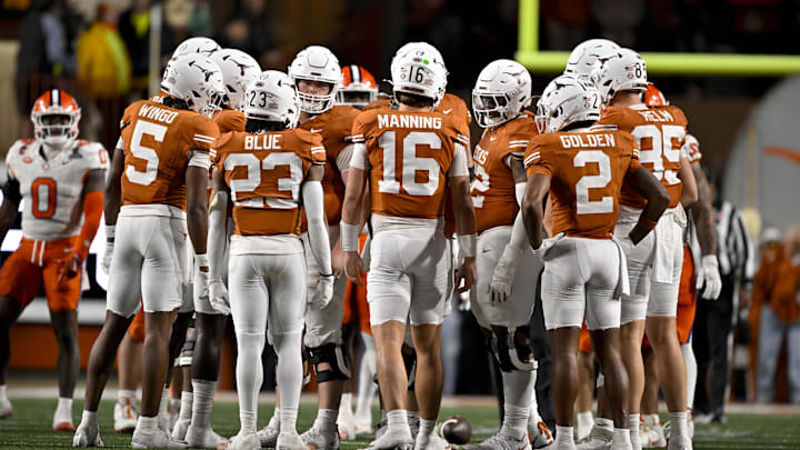 Texas Longhorns wide receiver Ryan Wingo (5) and running back Jaydon Blue (23) and quarterback Arch Manning (16) and wide receiver Matthew Golden (2) huddle with the team during the game between the Texas Longhorns and the Clemson Tigers in the CFP National Playoff First Round at Darrell K Royal-Texas Memorial Stadium.