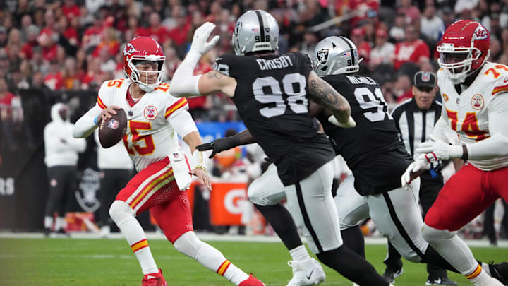 Nov 26, 2023; Paradise, Nevada, USA; Kansas City Chiefs quarterback Patrick Mahomes (15) is pressured by Las Vegas Raiders defensive end Maxx Crosby (98) and defensive tackle Bilal Nichols (91) in the first half at Allegiant Stadium. Mandatory Credit: Kirby Lee-USA TODAY Sports