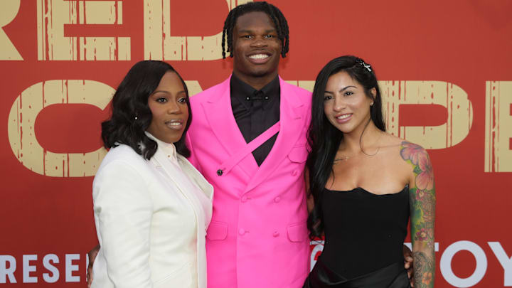 Colorado Buffaloes wide receiver Travis Hunter with his mother Ferrante Harris and his then fiancee Leanna Lenee on the red carpet before the 2025 NFL Draft at Lambeau Field.