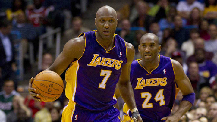 Nov 16, 2010; Milwaukee, WI, USA; Los Angeles Lakers forward Lamar Odom (7) dribbles the basketball in front of guard Kobe Bryant (24) during the game against the Milwaukee Bucks at the Bradley Center.  The Lakers defeated the Bucks 118-107.  Mandatory Credit: Jeff Hanisch-Imagn Images