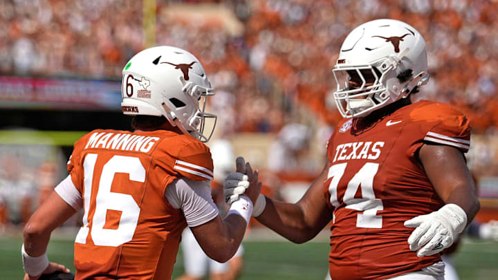 Sep 13, 2025; Austin, Texas, USA; Texas Longhorns quarterback Arch Manning (16) and offensive lineman Trevor Goosby (74) react after Manning ran for a touchdown during the first half against the Texas El Paso Miners at Darrell K Royal-Texas Memorial Stadium. Mandatory Credit: Scott Wachter-Imagn Images