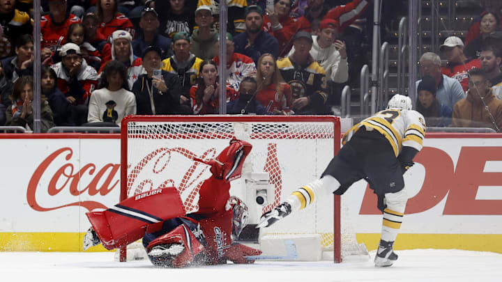 Mar 9, 2026; Washington, District of Columbia, USA; Boston Bruins center Fraser Minten (93) scores the game-winning goal on Washington Capitals goaltender Logan Thompson (48) in a shootout at Capital One Arena. Mandatory Credit: Geoff Burke-Imagn Images