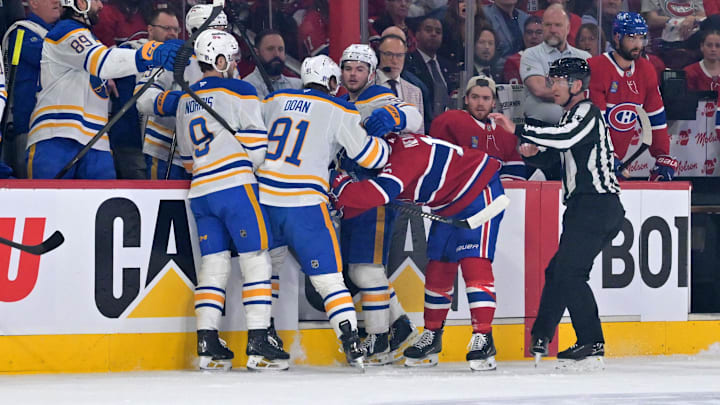 May 10, 2026; Montreal, Quebec, CAN; Buffalo Sabres players gang up on Montreal Canadiens forward Alex Newhook (15) during a line change during the first period in game three of the second round of the 2026 Stanley Cup Playoffs at the Bell Centre. Mandatory Credit: Eric Bolte-Imagn Images