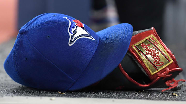 A baseball cap and glove sit on the Toronto Blue Jays dugout steps as the team hosts the Seattle Mariners at Rogers Centre in Toronto on April 8, 2024.