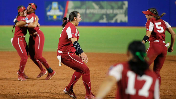 OU pitcher Hope Trautwein (7) runs toward Taylon Snow (5) to celebrate after beating Texas 10-5 on Thursday to win the NCAA softball title.