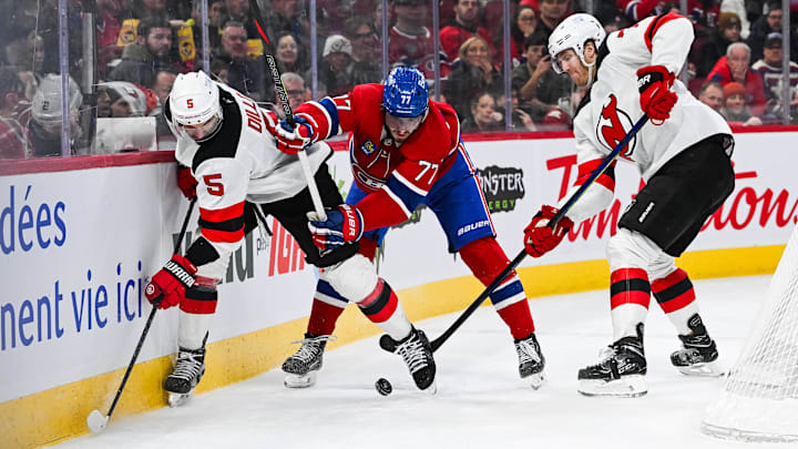 Feb 8, 2025; Montreal, Quebec, CAN; New Jersey Devils defenseman Brenden Dillon (5) and defenseman Dougie Hamilton (7) defend the puck against Montreal Canadiens center Kirby Dach (77) near the boards during the second period at Bell Centre. Mandatory Credit: David Kirouac-Imagn Images Feb 8, 2025; Montreal, Quebec, CAN; New Jersey Devils defenseman Brenden Dillon (5) and defenseman Dougie Hamilton (7) defend the puck against Montreal Canadiens center Kirby Dach (77) near the boards during the second period at Bell Centre. Mandatory Credit: David Kirouac-Imagn Images