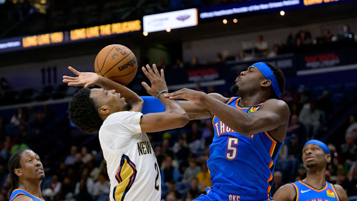 Dec 7, 2024; New Orleans, Louisiana, USA; New Orleans Pelicans forward Herbert Jones (2) shoots against Oklahoma City Thunder guard Luguentz Dort (5) during the second half at Smoothie King Center. Mandatory Credit: Matthew Hinton-Imagn Images