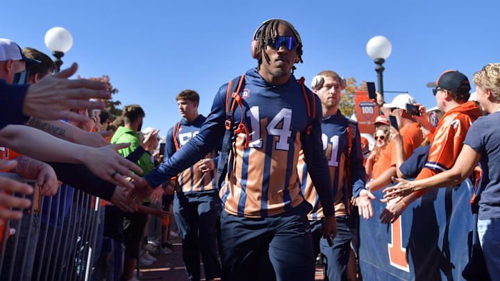 Oct 19, 2024; Champaign, Illinois, USA; Illinois Fighting Illini defensive back Xavier Scott (14) and teammates do the Illini Walk before kickoff against the Michigan Wolverines game at Memorial Stadium. Mandatory Credit: Ron Johnson-Imagn Images