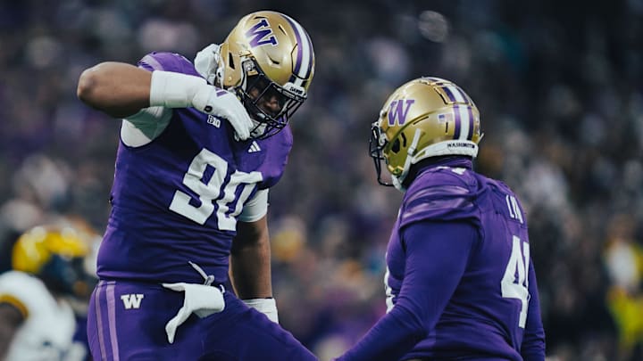 Elinneus Davis celebrates a pass deflection with Deshawn Lynch for the Huskies. 