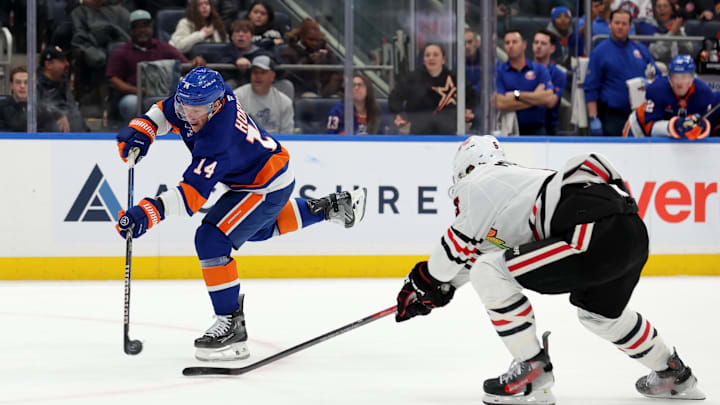 Dec 12, 2024; Elmont, New York, USA; New York Islanders center Bo Horvat (14) takes a shot against Chicago Blackhawks defenseman Connor Murphy (5) during the second period at UBS Arena. Mandatory Credit: Brad Penner-Imagn Images