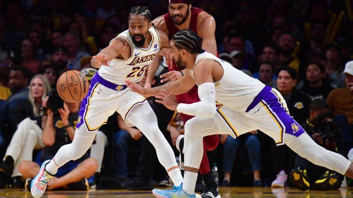 Apr 6, 2024; Los Angeles, California, USA; Los Angeles Lakers guard Spencer Dinwiddie (26) and guard Gabe Vincent (7) plays for the ball against Cleveland Cavaliers center Jarrett Allen (31) during the second half at Crypto.com Arena. Mandatory Credit: Gary A. Vasquez-USA TODAY Sports
