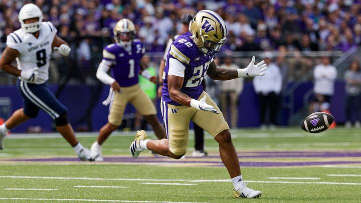 Sep 12, 2026; Seattle, Washington, USA; Washington Huskies running back Trey Cooley (22) drops a fourth down pass against the Utah State Aggies during the first quarter at Husky Stadium. Mandatory Credit: Joe Nicholson-Imagn Images