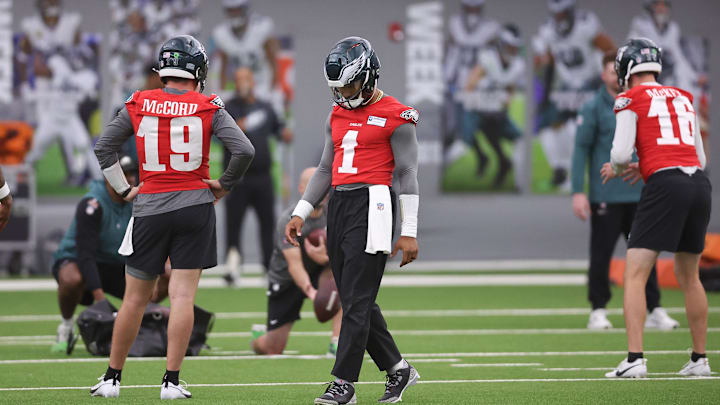 May 28, 2025; Philadelphia, PA, USA; Philadelphia Eagles quarterback Jalen Hurts (1) walks between Tanner McKee (16) and Kyle McCord (19) during OTAs at NovaCare Complex. Mandatory Credit: Bill Streicher-Imagn Images