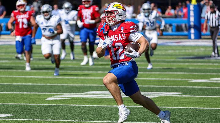 Oct 3, 2026; Lawrence, Kansas, USA; Kansas Jayhawks wide receiver Bryson Hayes (12) finds room to run after a catch in the fourth quarter against the Middle Tennessee Blue Raiders at David Booth Kansas Memorial Stadium. Mandatory Credit: Scott Sewell-Imagn Images Oct 3, 2026; Lawrence, Kansas, USA; Kansas Jayhawks wide receiver Bryson Hayes (12) finds room to run after a catch in the fourth quarter against the Middle Tennessee Blue Raiders at David Booth Kansas Memorial Stadium. Mandatory Credit: Scott Sewell-Imagn Images