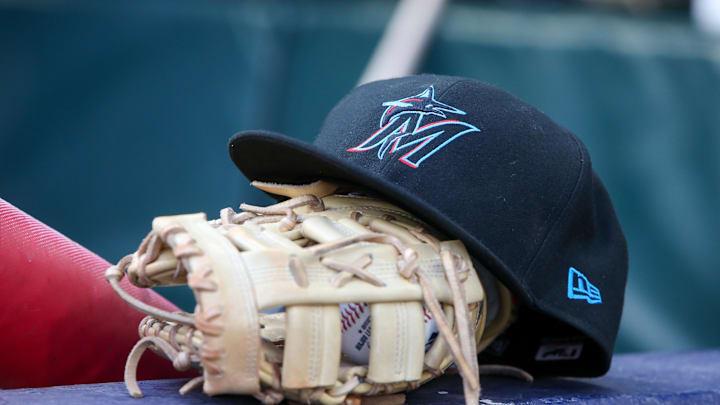 Apr 24, 2024; Atlanta, Georgia, USA; A detailed view of a Miami Marlins hat and glove in the dugout before a game against the Atlanta Braves at Truist Park. Mandatory Credit: Brett Davis-Imagn Images