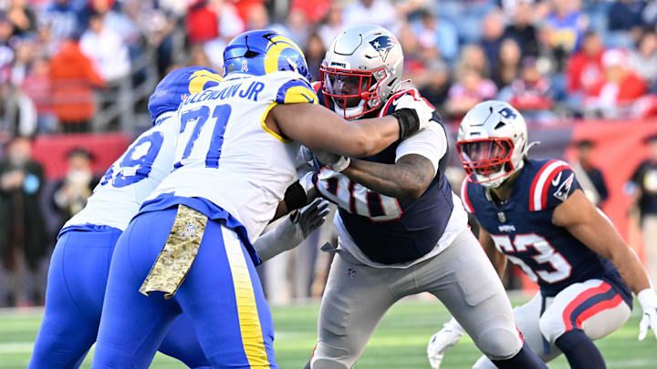 Nov 17, 2024; Foxborough, Massachusetts, USA; New England Patriots defensive tackle Christian Barmore (90) blocks Los Angeles Rams offensive tackle Warren McClendon Jr. (71) during the first half at Gillette Stadium. Mandatory Credit: Eric Canha-Imagn Images