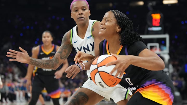 Sep 26, 2025; Phoenix, Arizona, USA; Phoenix Mercury guard Monique Akoa Makani (8) drives the ball as Minnesota Lynx guard Courtney Williams (10) defends during game three of the second round for the 2025 WNBA Playoffs at PHX Arena. Mandatory Credit: Rick Scuteri-Imagn Images