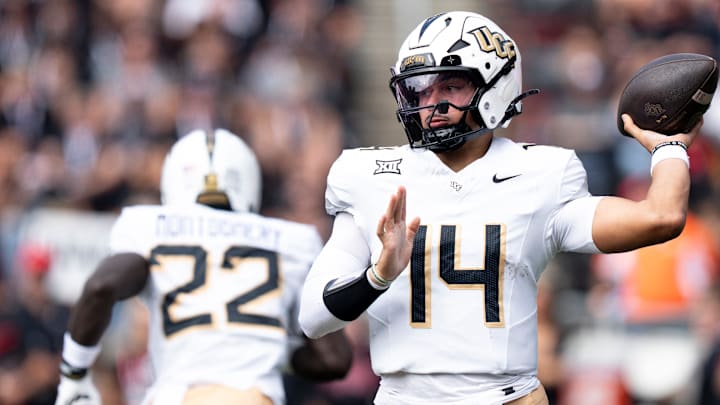 UCF Knights quarterback Cam Fancher (14) throws a pass in the first quarter of the NCAA football game between the Cincinnati Bearcats and UCF Knights at Nippert Stadium in Cincinnati on Oct. 11, 2025. UCF Knights quarterback Cam Fancher (14) throws a pass in the first quarter of the NCAA football game between the Cincinnati Bearcats and UCF Knights at Nippert Stadium in Cincinnati on Oct. 11, 2025.