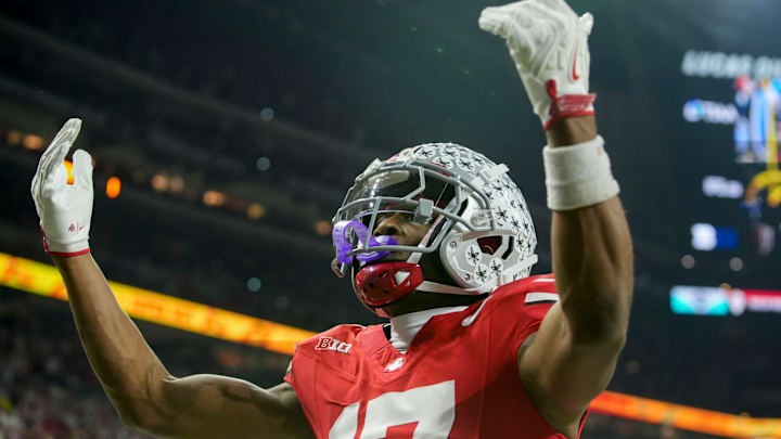 Ohio State Buckeyes wide receiver Carnell Tate (17) celebrates a touchdown Saturday, Dec. 6, 2025, during the Big Ten football championship against the Indiana Hoosiers at Lucas Oil Stadium in Indianapolis.