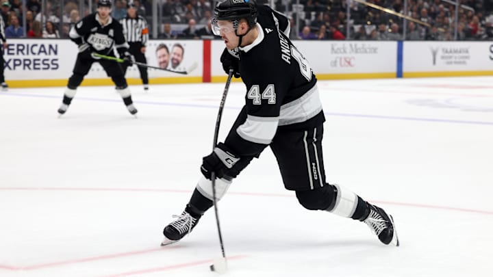 Oct 24, 2024; Los Angeles, California, USA; Los Angeles Kings defenseman Mikey Anderson (44) shoots during the second against the San Jose Sharks period at Crypto.com Arena. Mandatory Credit: Jason Parkhurst-Imagn Images