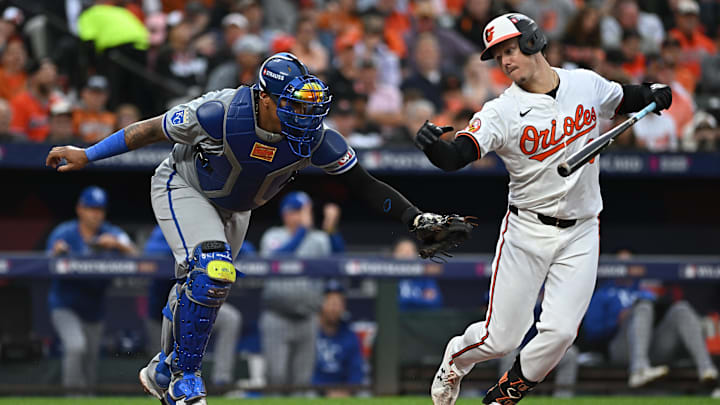 Oct 1, 2024; Baltimore, Maryland, USA; Kansas City Royals catcher Salvador Perez (13) tries to tag out Baltimore Orioles first base Ryan Mountcastle (6) on a strike out in the fourth inning in game one of the Wild Card round for the 2024 MLB Playoffs at Oriole Park at Camden Yards. 